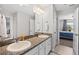Shared bathroom with double sinks and granite countertop at 12211 Streambed Dr, Riverview, FL 33579
