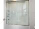Clean bathroom with a shower/tub combo and sliding glass doors at 12211 Streambed Dr, Riverview, FL 33579