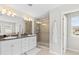 Elegant bathroom with double sinks and a large shower at 12211 Streambed Dr, Riverview, FL 33579