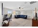 Spacious bonus room with ample natural light, comfortable seating area, and a workspace at 12211 Streambed Dr, Riverview, FL 33579