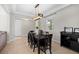Bright dining room with a dark wood table, six chairs, and an entryway view at 12211 Streambed Dr, Riverview, FL 33579