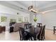 Dining room with a rustic wood table, six chairs, and an open view of the living room at 12211 Streambed Dr, Riverview, FL 33579
