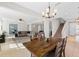 Open concept dining room with a rustic wood table and view into the living room at 12211 Streambed Dr, Riverview, FL 33579