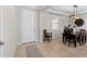 Bright entryway with tile flooring, a white door, and view into dining area at 12211 Streambed Dr, Riverview, FL 33579