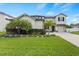 Two-story house with a landscaped yard and driveway at 12211 Streambed Dr, Riverview, FL 33579