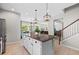 Island kitchen with granite countertops, white cabinets, and an open concept design at 12211 Streambed Dr, Riverview, FL 33579