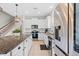 Modern kitchen with stainless steel appliances, granite counters and white cabinets at 12211 Streambed Dr, Riverview, FL 33579