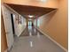 Long hallway with wood-look floors and light walls at 6513 48Th N Ave, Kenneth City, FL 33709