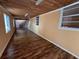 Long hallway with wood-look floors and light walls at 6513 48Th N Ave, Kenneth City, FL 33709