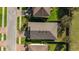 Aerial view of a single Gathering home with dark roof, well-maintained lawn, and two-car parking in the driveway at 1570 Fox Grape Loop, Lutz, FL 33558