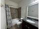 Full bathroom with granite vanity, updated faucet, tub, tiled shower, and decorative shower curtain at 1570 Fox Grape Loop, Lutz, FL 33558