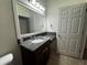 Bathroom featuring a vanity with granite countertop, stylish lighting, and a framed mirror at 1570 Fox Grape Loop, Lutz, FL 33558