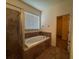 Bathroom with shower and separate bathtub with tile surround at 1570 Fox Grape Loop, Lutz, FL 33558