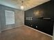 Bedroom with dark accent wall, natural light, and modern chandelier at 1570 Fox Grape Loop, Lutz, FL 33558