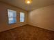 Empty bedroom with large windows, neutral paint, and tile flooring at 1570 Fox Grape Loop, Lutz, FL 33558