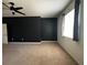 Spacious bedroom with dark accent wall, ceiling fan, and natural light at 1570 Fox Grape Loop, Lutz, FL 33558