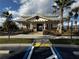 Exterior view of the community center, including accessible access, palm trees, and a wreath on the door at 1570 Fox Grape Loop, Lutz, FL 33558