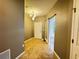 Foyer with tile flooring, chandelier, and a sliding barn door leading to the bedrooms at 1570 Fox Grape Loop, Lutz, FL 33558