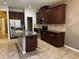 Well-equipped kitchen with stainless steel appliances, tile floors, and a granite-topped center island at 1570 Fox Grape Loop, Lutz, FL 33558
