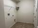 A simple laundry room with tile floors, wire shelving, and a utility sink connection at 1570 Fox Grape Loop, Lutz, FL 33558