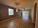 Bright living room featuring tile floors, ceiling fan, pendant lights, and a sliding door at 1570 Fox Grape Loop, Lutz, FL 33558