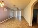 Spacious living room with neutral walls, tile flooring, a ceiling fan, and a sliding glass door for ample natural light at 1570 Fox Grape Loop, Lutz, FL 33558