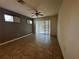 Large living area with tile flooring, ceiling fan, backyard access, and neutral paint at 1570 Fox Grape Loop, Lutz, FL 33558