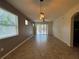 Spacious living room with tile flooring, ceiling fan, and sliding glass doors to the backyard at 1570 Fox Grape Loop, Lutz, FL 33558