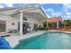 Resort-style backyard with a sparkling pool, patio area, and lush landscaping for outdoor living at 5923 Sandstone Ave, Sarasota, FL 34243