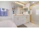 Bathroom with white cabinets, granite countertops, framed mirrors, a tub, and a separate glass-enclosed shower at 5923 Sandstone Ave, Sarasota, FL 34243