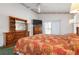 Bedroom with king-size bed, dresser, and sliding glass doors at 5923 Sandstone Ave, Sarasota, FL 34243