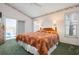 Main bedroom with a king-size bed and sliding glass doors to patio at 5923 Sandstone Ave, Sarasota, FL 34243