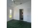 Bright bedroom with an expansive window for natural light and a door leading to the rest of the home at 5923 Sandstone Ave, Sarasota, FL 34243