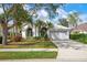 Single-story home with a white exterior, landscaping, and a two-car garage at 5923 Sandstone Ave, Sarasota, FL 34243
