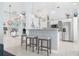 Open kitchen with island, stainless steel appliances, and breakfast bar at 5923 Sandstone Ave, Sarasota, FL 34243