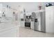 Stylish kitchen with stainless appliances, white cabinets, granite counters, and tile backsplash at 5923 Sandstone Ave, Sarasota, FL 34243
