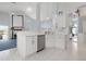 Open kitchen features stainless appliances, white cabinets, and a breakfast bar with seating at 5923 Sandstone Ave, Sarasota, FL 34243