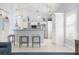 Updated kitchen with white cabinets, breakfast bar, stainless appliances, and modern lighting at 5923 Sandstone Ave, Sarasota, FL 34243