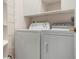 Laundry room with washer, dryer, and shelving at 5923 Sandstone Ave, Sarasota, FL 34243