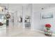 Bright living room with tile flooring, neutral paint, and an open floor plan to the kitchen area at 5923 Sandstone Ave, Sarasota, FL 34243