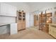 Bright office/bedroom space featuring built-in cabinets, closet space, and neutral decor at 5923 Sandstone Ave, Sarasota, FL 34243
