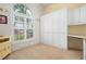 Well-lit office space with built-in storage and a large window offering a view of the outdoors at 5923 Sandstone Ave, Sarasota, FL 34243
