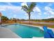 Outdoor pool with a palm tree and view of the lake at 5923 Sandstone Ave, Sarasota, FL 34243