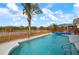 Inviting swimming pool with a tranquil view of a pond and lush greenery at 5923 Sandstone Ave, Sarasota, FL 34243