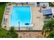 Aerial view of an in-ground pool surrounded by lounge chairs at 5923 Sandstone Ave, Sarasota, FL 34243