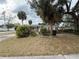 Brick home with mature landscaping and a large front yard at 6002 Town N Country Blvd, Tampa, FL 33615