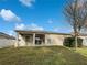 Landscaped backyard with a covered patio at 34434 Windknob Ct, Wesley Chapel, FL 33545