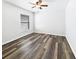 Simple bedroom with wood-look floors and a window with blinds at 34434 Windknob Ct, Wesley Chapel, FL 33545