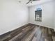 Simple bedroom with wood-look flooring and large window at 34434 Windknob Ct, Wesley Chapel, FL 33545
