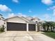 Two-car garage and well-maintained landscaping at 34434 Windknob Ct, Wesley Chapel, FL 33545